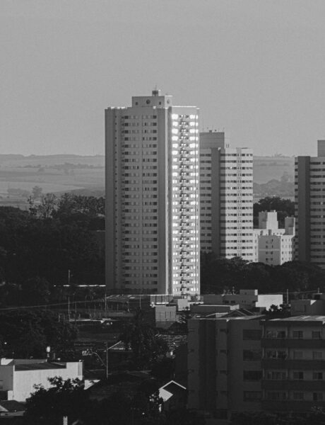 Black-and-white cityscape with tall residential apartment buildings