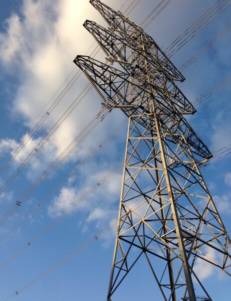 Electricity transmission pylon against a blue sky with power lines